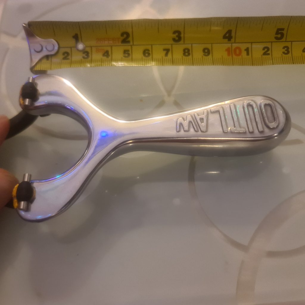 OUTLAW slingshot shown against ruler for length